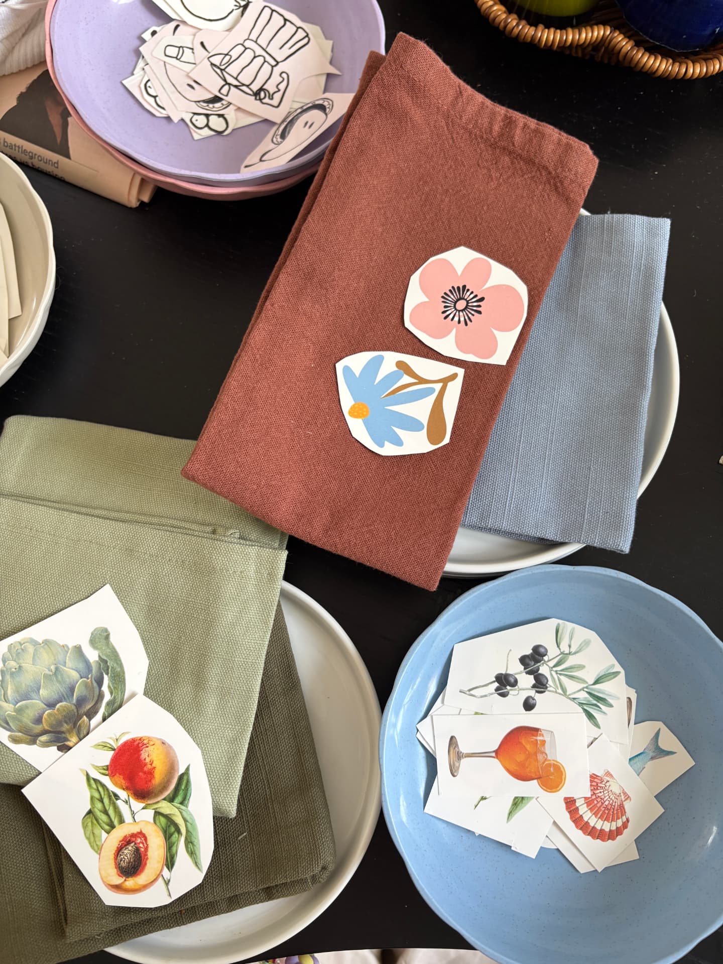 Napkins and printed motifs laid out on ceramic plates ready to decorate