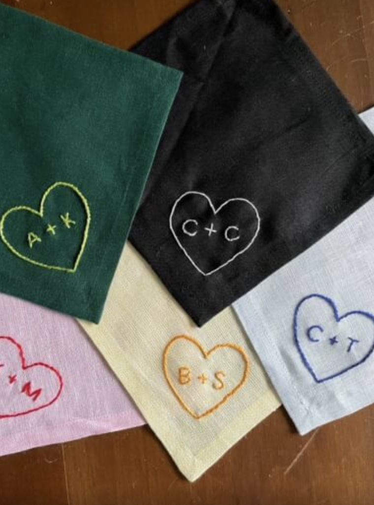 Linen napkins hand-embroidered with initials inside hearts